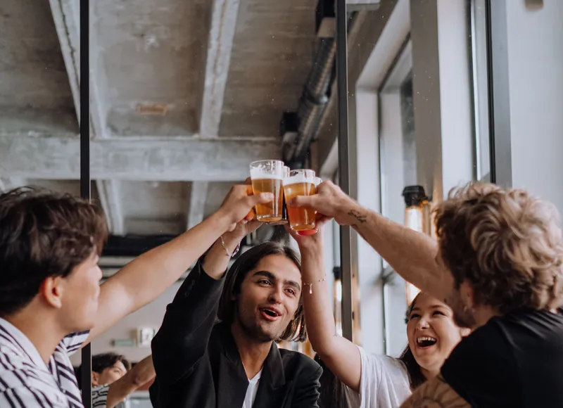 Friends cheering at a bar
