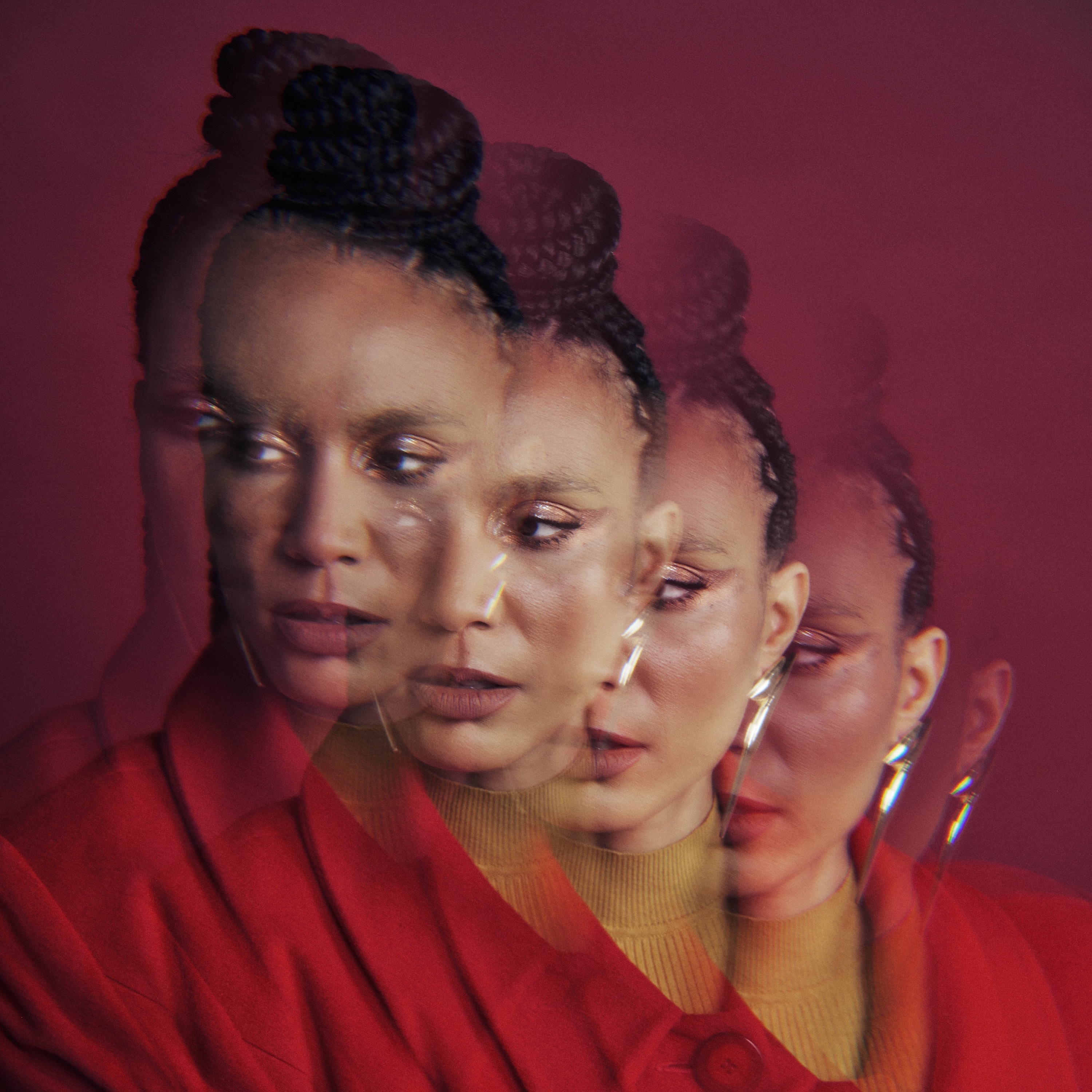 In front of a burgundy background, a portrait image of Anaïs Maviel, dressed in red with a braided bun coiled on top of her head, is repeated in a diagonal overlapping pattern from top left to bottom right