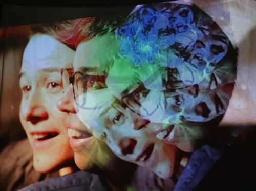 Repeating side-by-side profile images of Chloé Ziner and Jessica Gabriel start on the left and tilt into a spiral on the right tinted in colours that fade from red to green to blue.