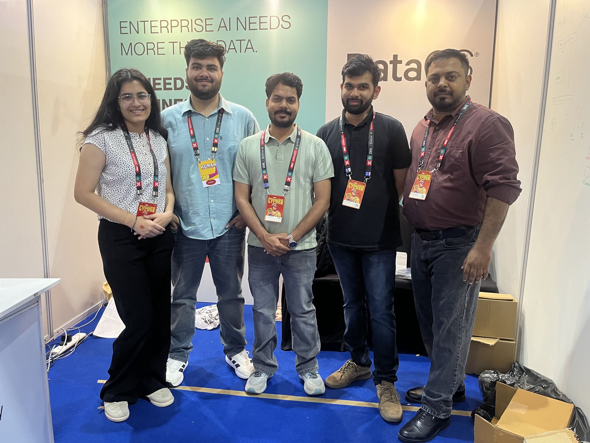 Five members of The Modern Data Company team at the DataOS booth at Cypher 2026, standing beneath a banner reading ‘Enterprise AI needs more than data.’