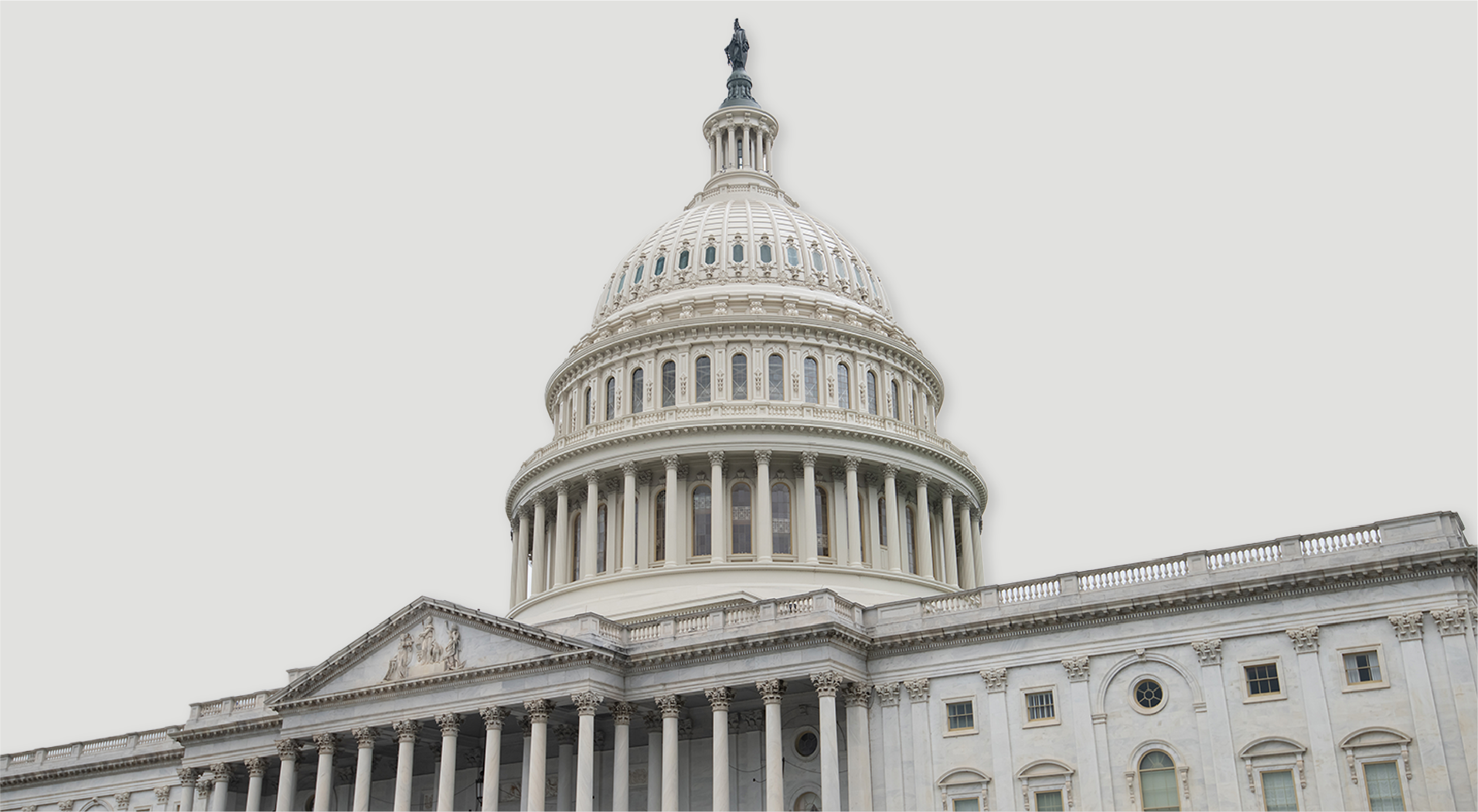 Close-up of the dome and columns of the United States Capitol building against a light gray sky.