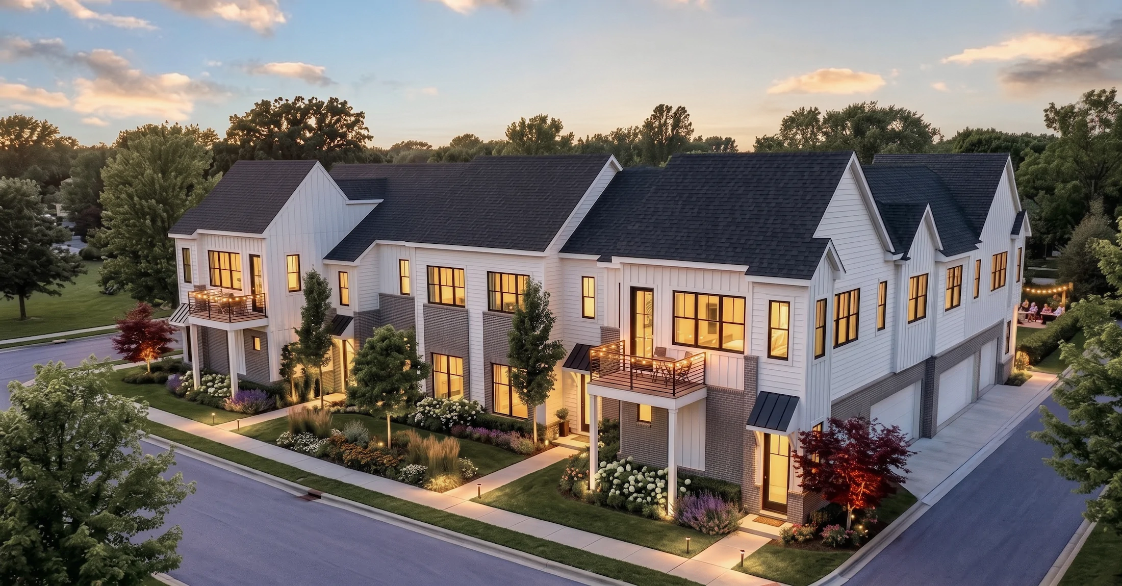 Townhomes with balconies and evening lighting at Troy Trail North