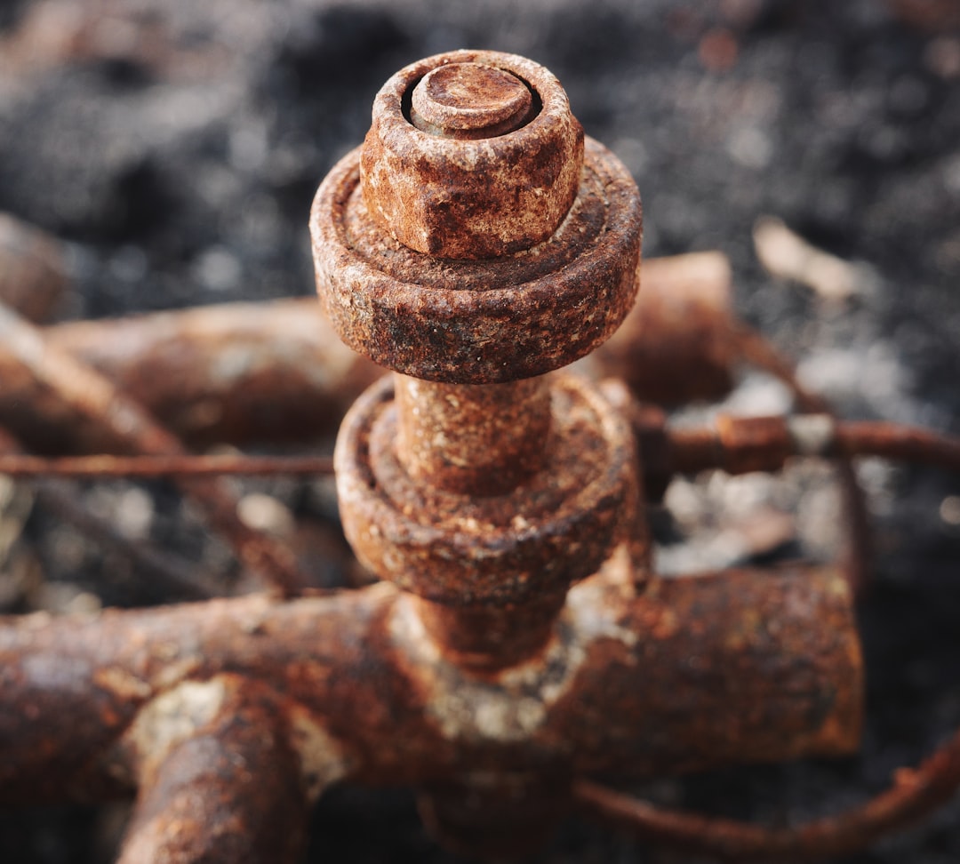 corroded residential gas pipe with visible rust and fittings