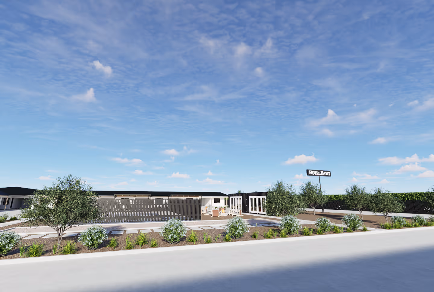 Modern hotel exterior with outdoor seating, greenery, and a sign reading 'Hotel Bayit' under a blue sky.