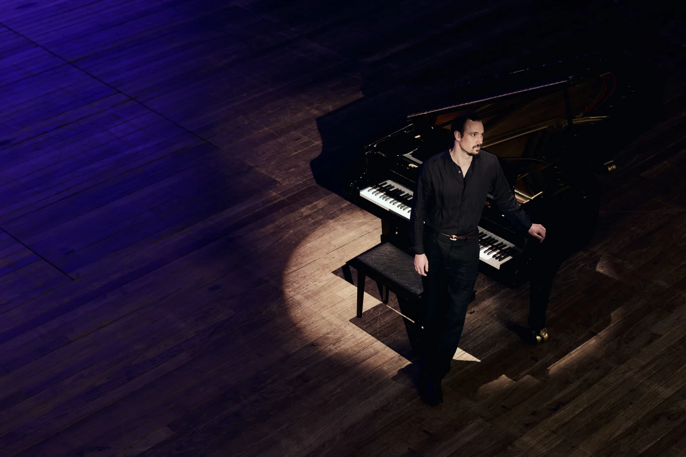 Eric Christian seated at a grand piano