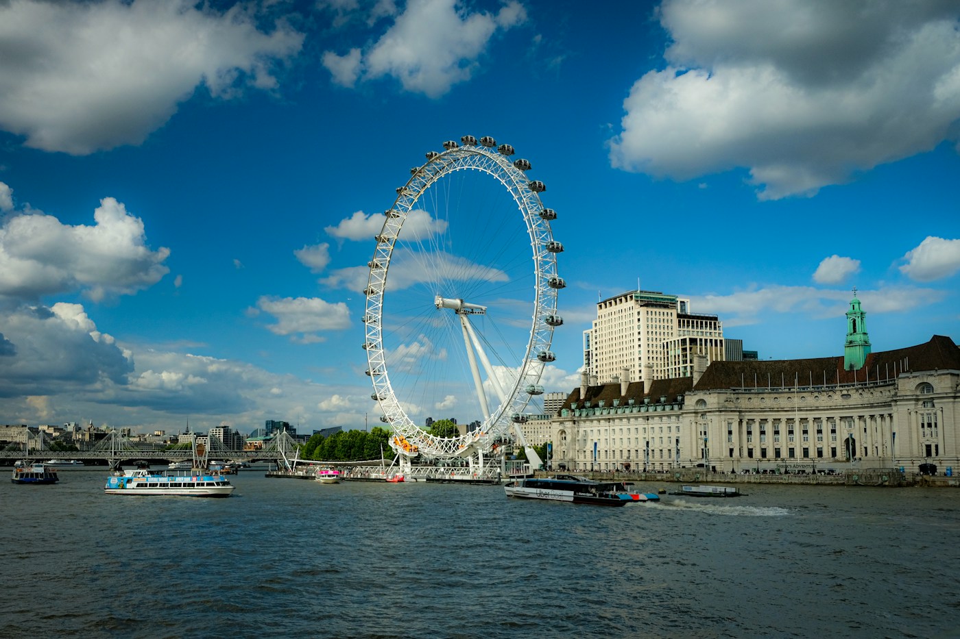 The London Eye, riverboats and South Bank buildings seen from Westminster Bridge