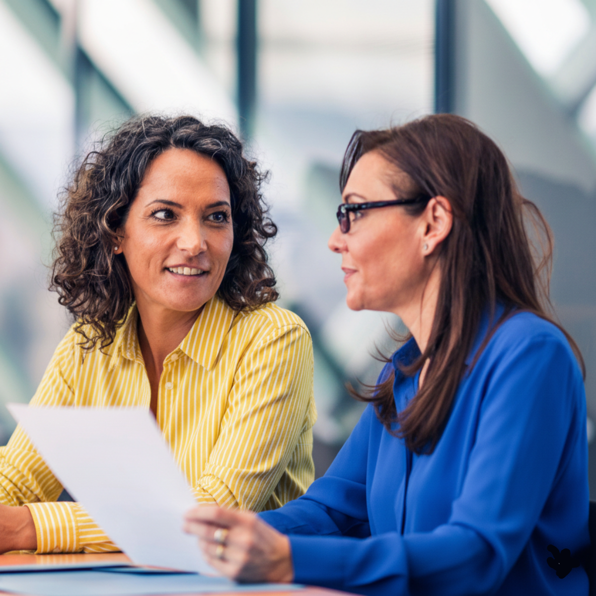 Two mortgage professionals having a conversation about mortgage licensing software