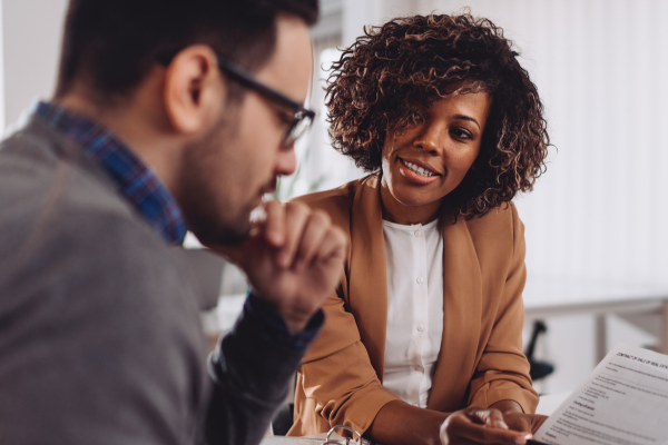 Person reviewing consumer loan servicing agreement at desk