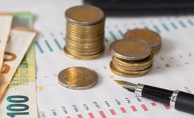 Stacks of coins and financial documents illustrating the abolition of the Lifetime Allowance in the UK budget