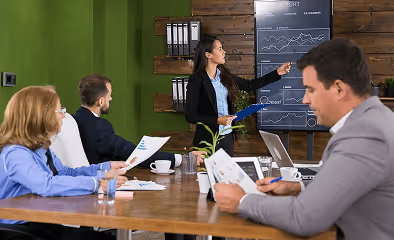 Financial advisors presenting investment data while discussing the best SIPP options for EU residents