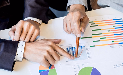 Financial professionals analyzing charts and discussing investment risk management strategies