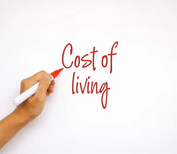 a hand writing on a whiteboard Cost of living in France