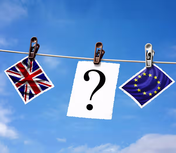 UK and EU flags with a question mark representing Brexit uncertainty.