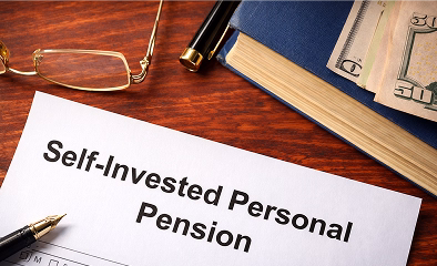 Self-Invested Personal Pension document on a desk.