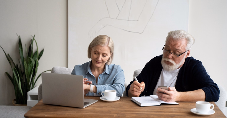 Senior couple planning retirement finances at home