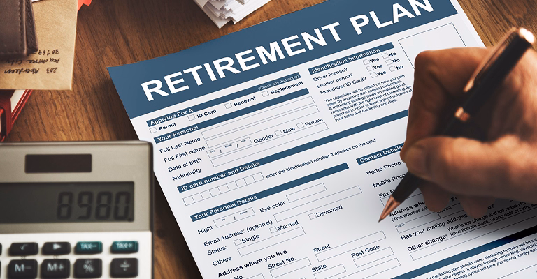 Filling out a retirement plan form with calculator