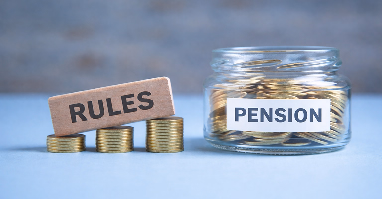 lass jar labeled pension with coins and wood block with a word rules on stacks of coins