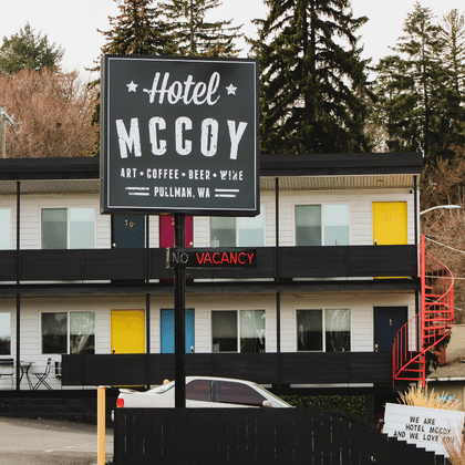 An exterior view of the Hotel McCoy in Pullman, WA, featuring its main black sign