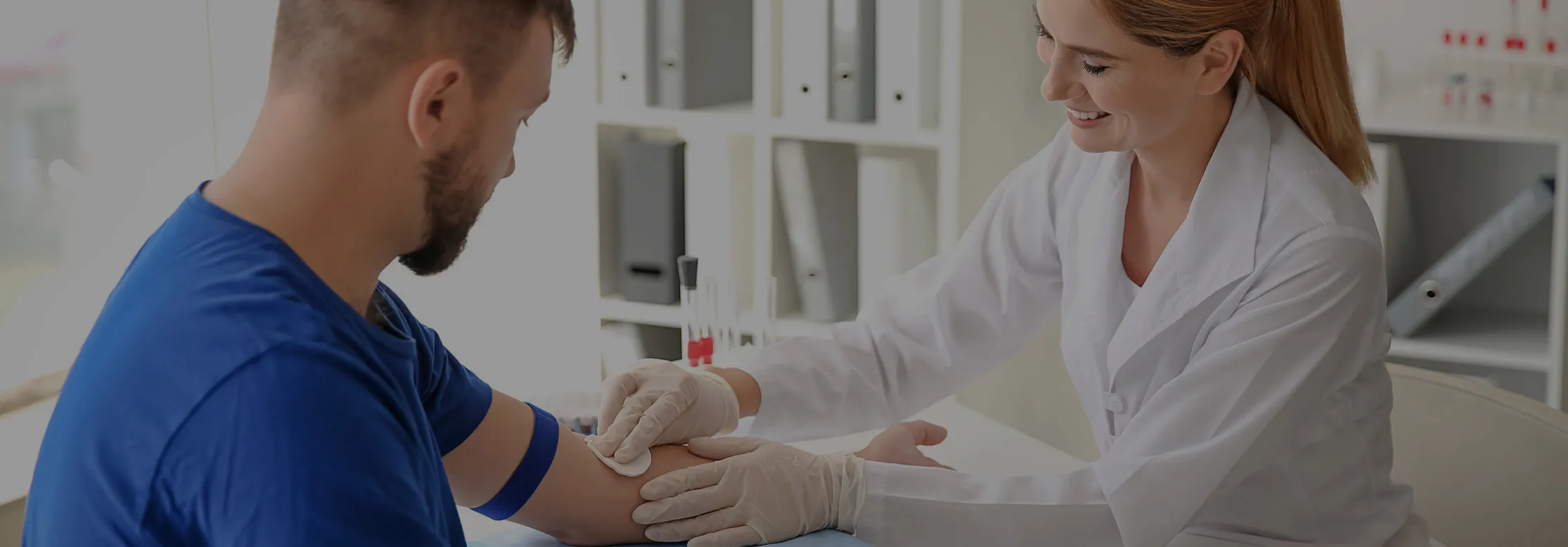 A man having a blood sample taken by a clinician at Eden Clinic
