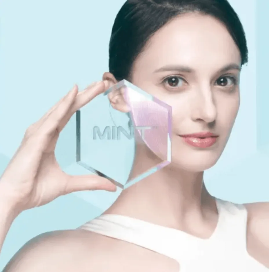 A woman holding a MINT thread pack up against her cheek