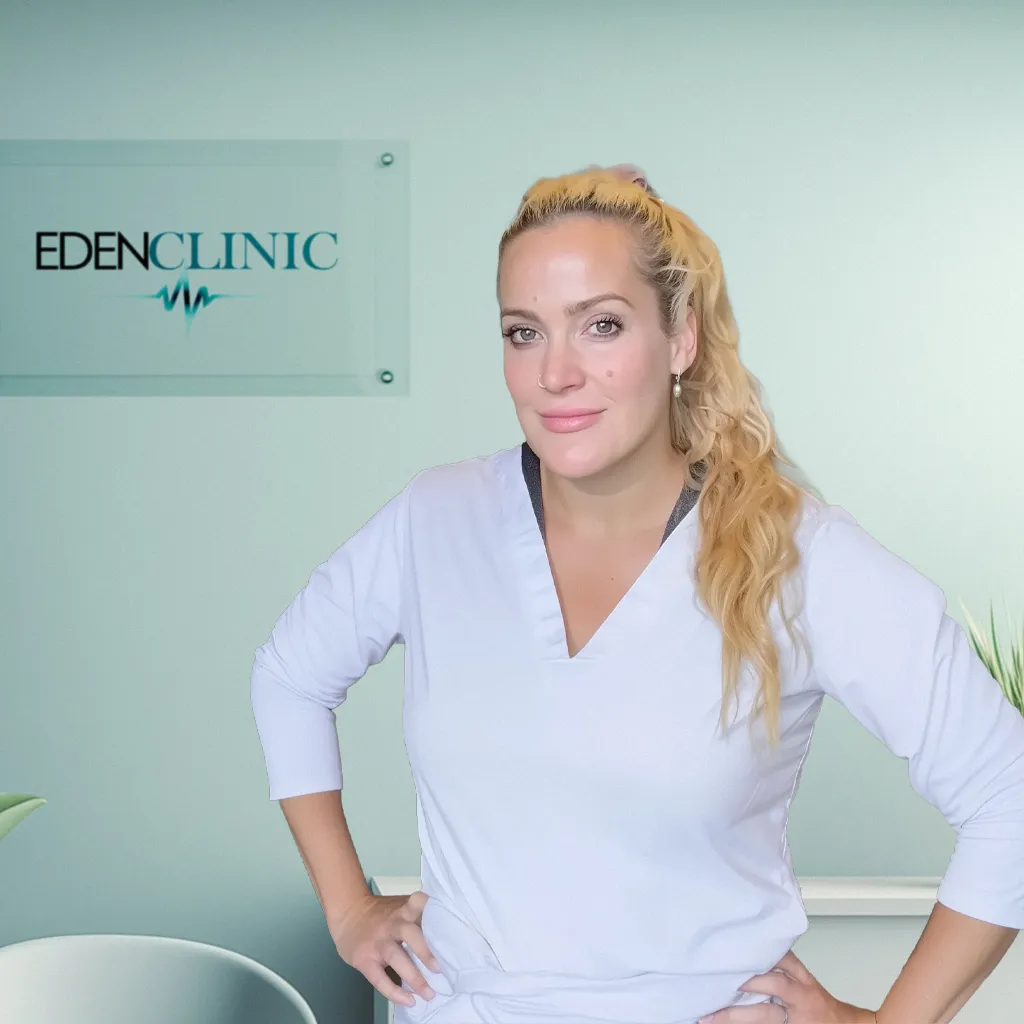Dr Angela Servis in a white coat in the consulting room at Eden Clinic