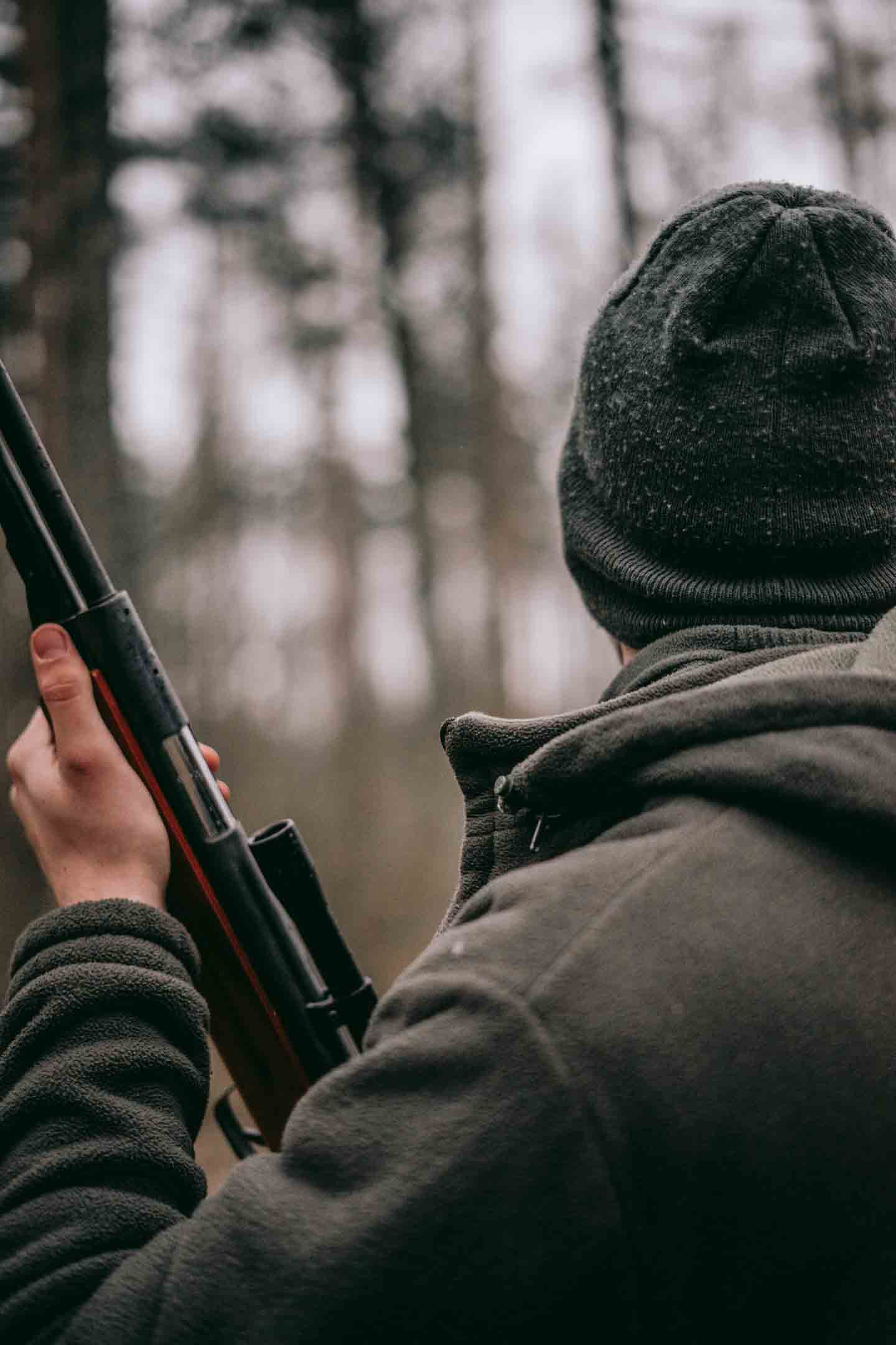 Man surveying the woods as he hunts