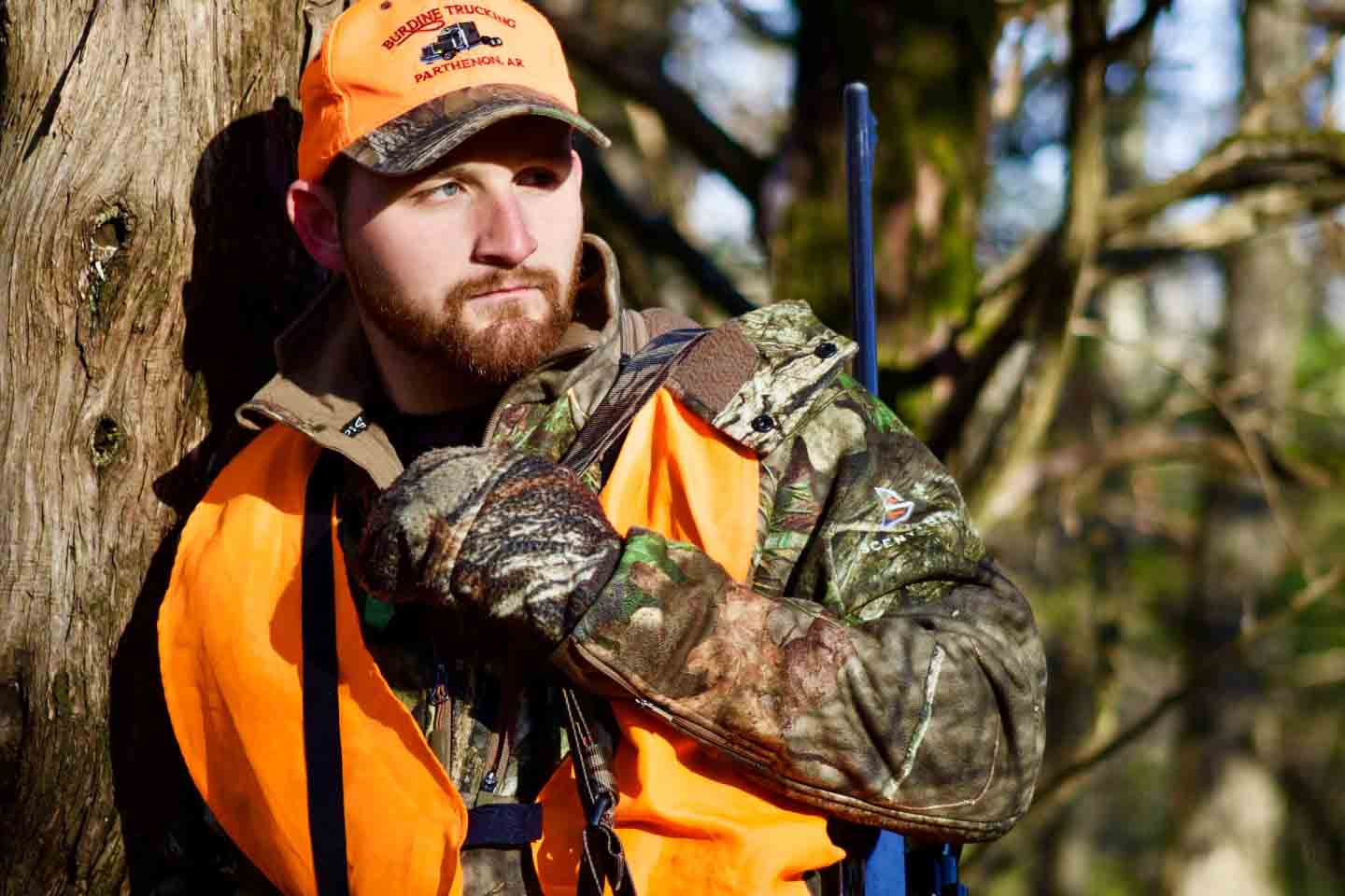 Man hunts wearing safety orange vest