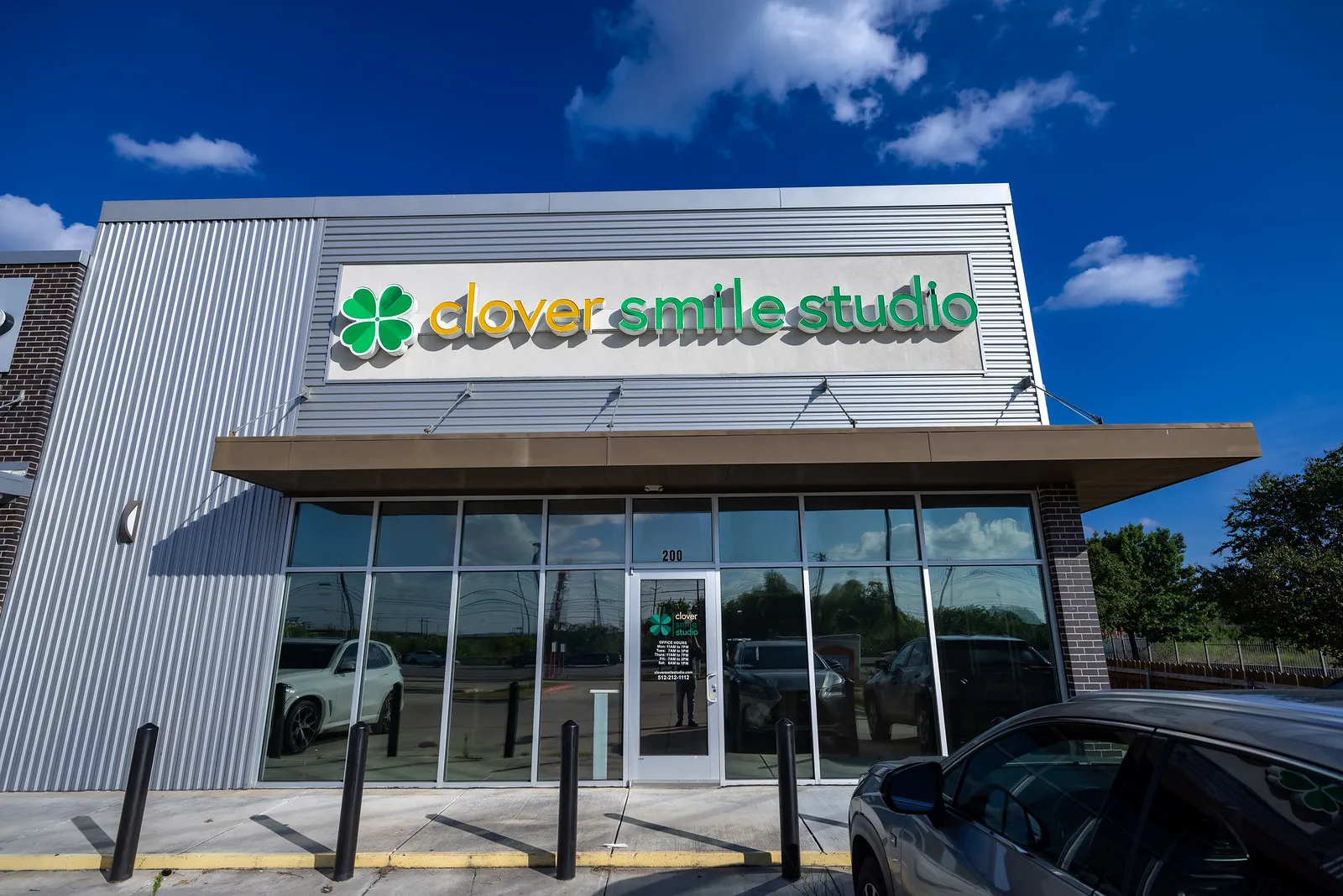 Exterior view of Clover Smiles Studio dental clinic showing modern building and signage