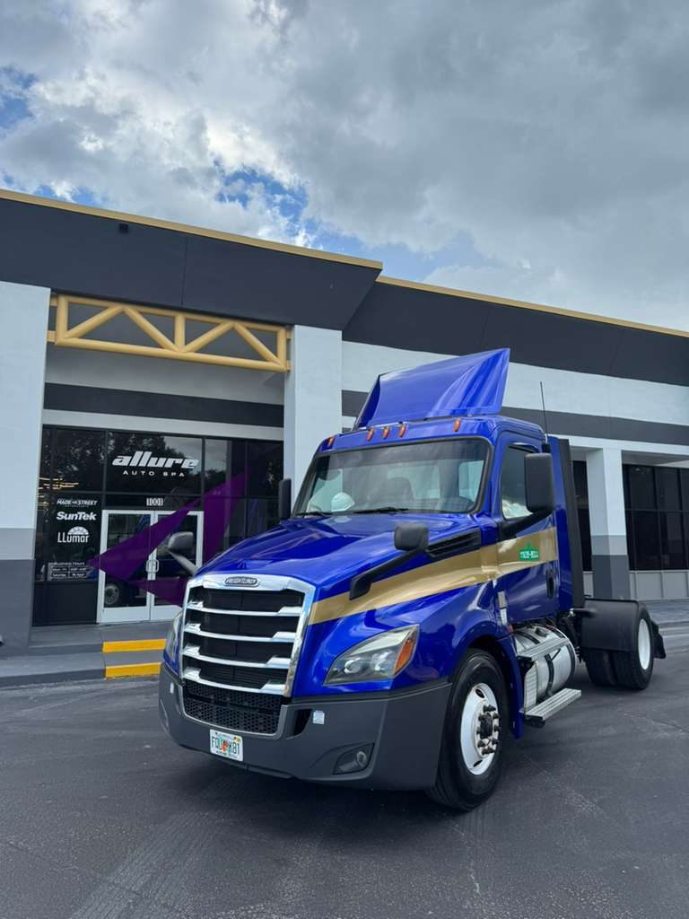 Branded Freightliner in front of Allure Auto Spa