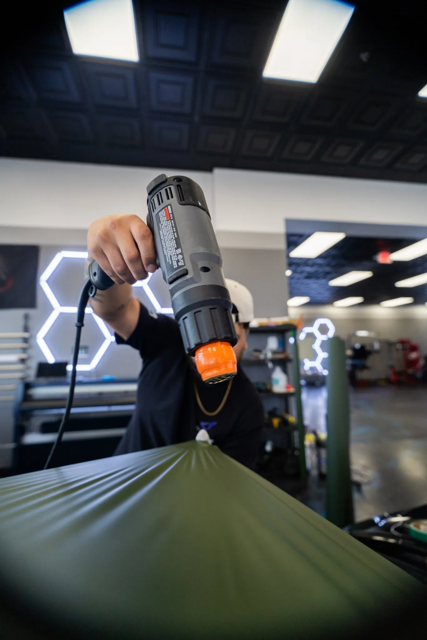 Vinyl wrap film heat-installed by hand inside Allure Auto Spa, Winter Park FL