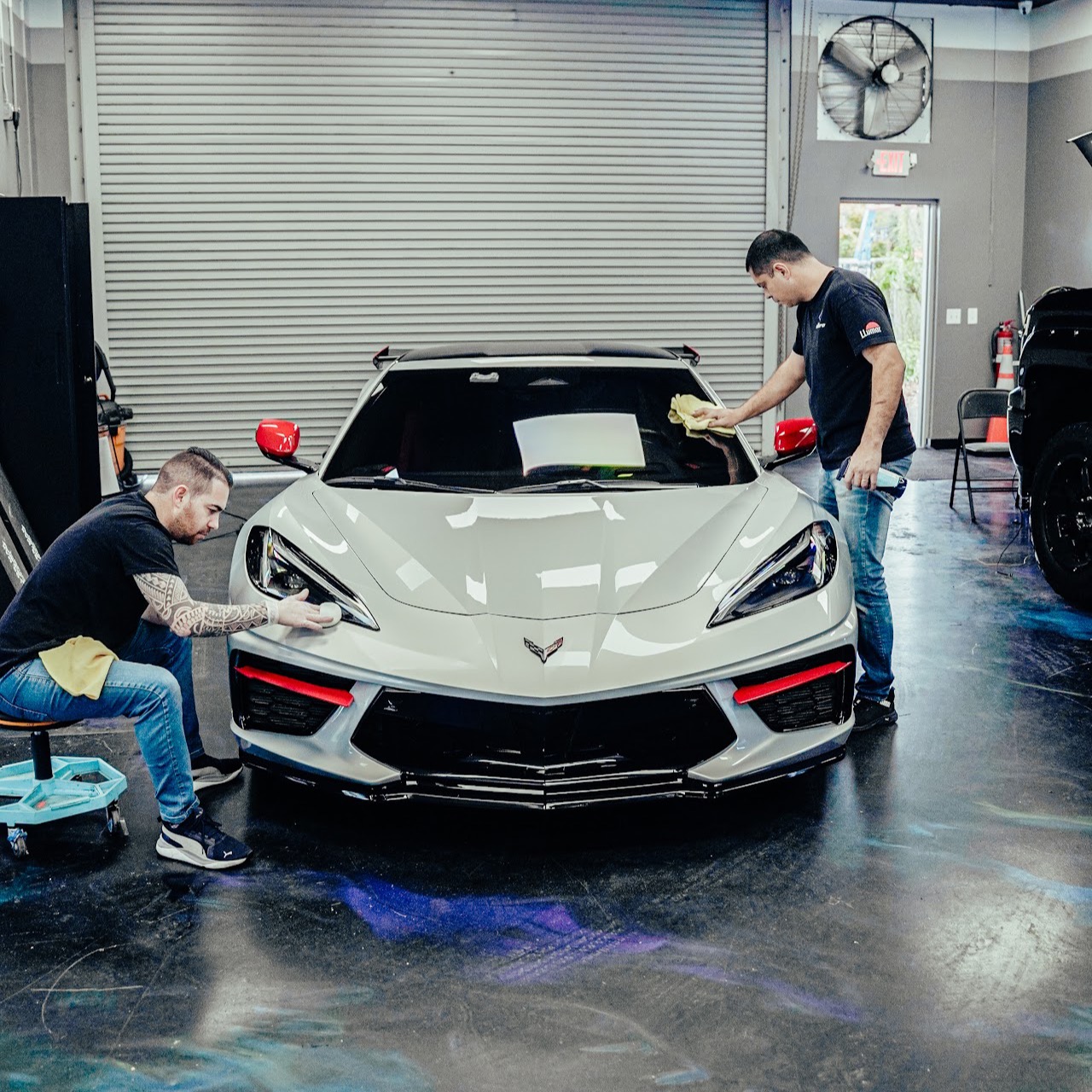 Allure Auto Spa technicians applying ceramic coating to a Corvette C8