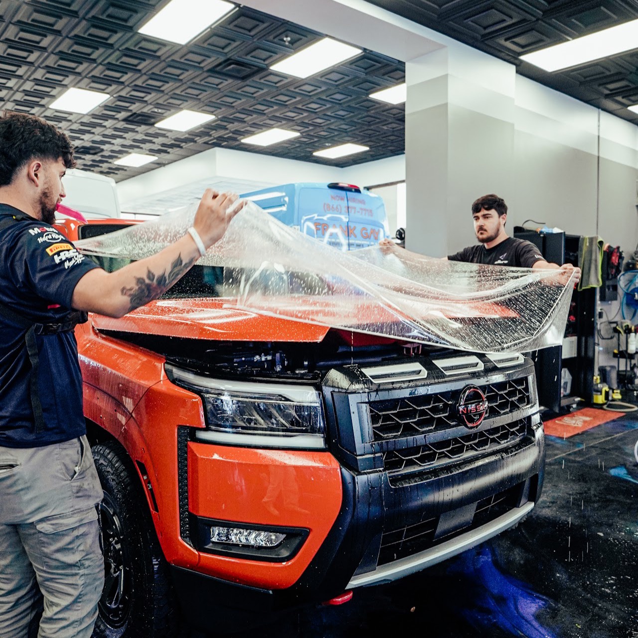 Allure Auto Spa technicians installing paint protection film on a truck