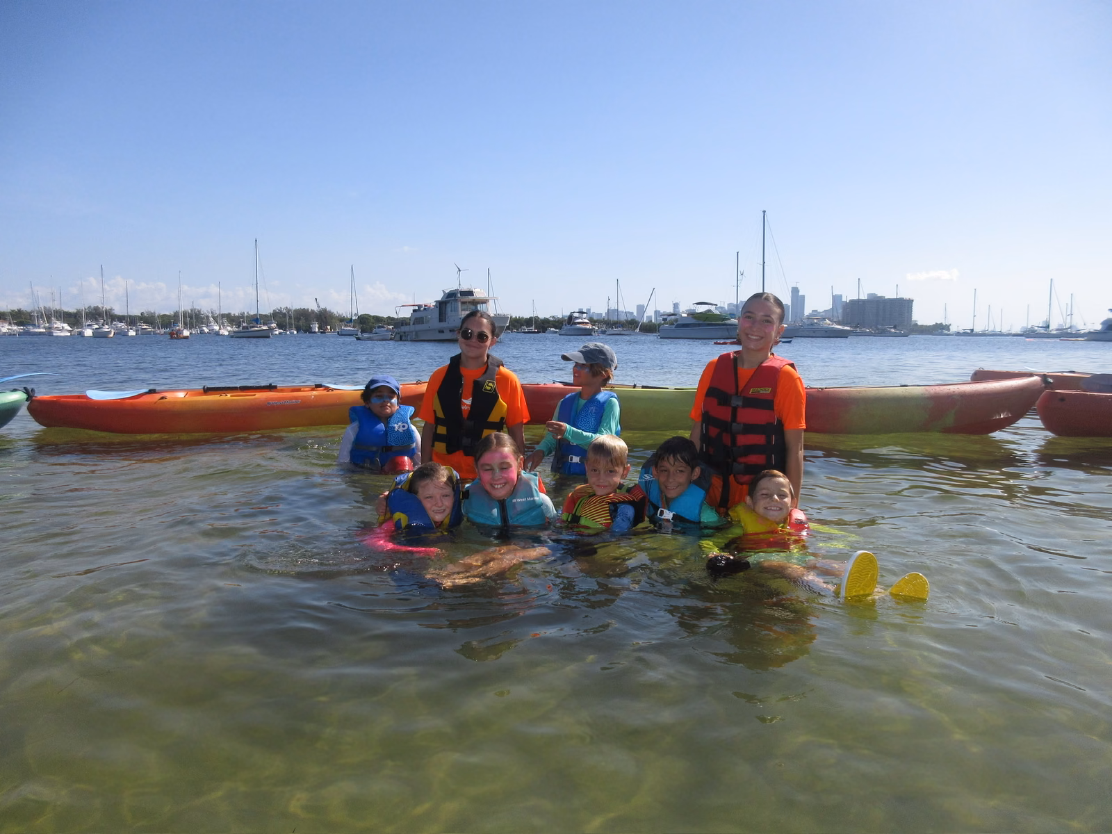 Group in shallows with kayaks