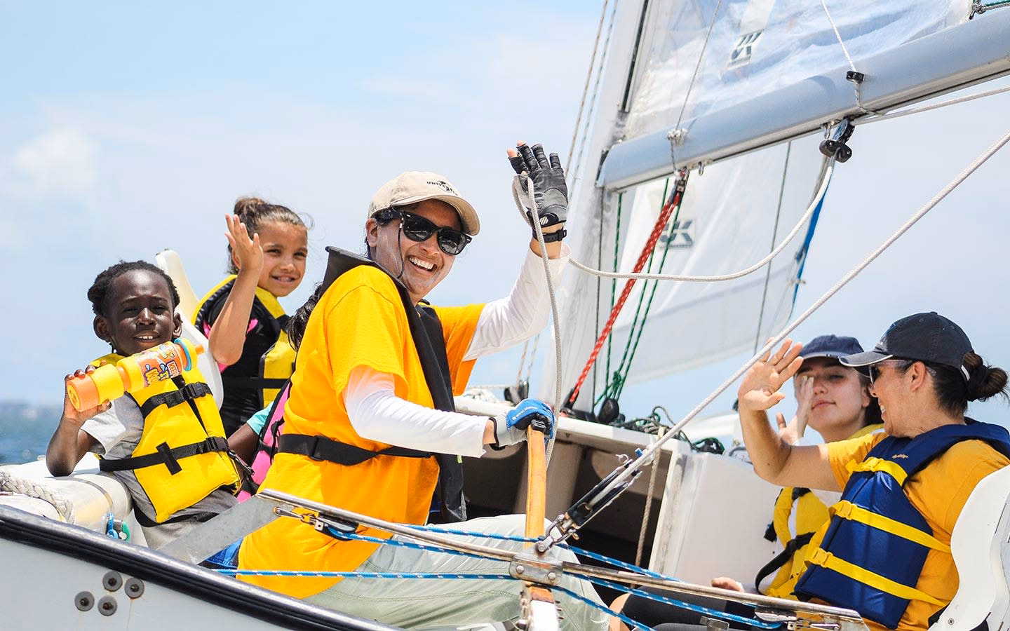 Instructor and girls waving aboard