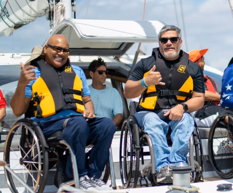 Adaptive sailors thumbs up aboard