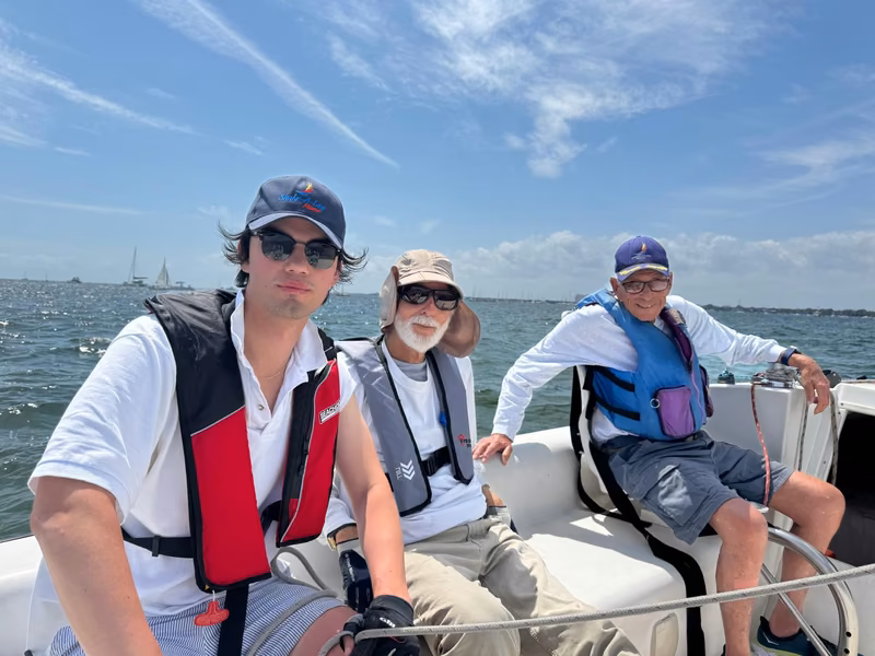 Three sailors aboard on the bay
