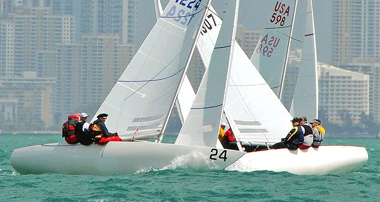 Two Etchells keelboats racing with the Miami skyline behind
