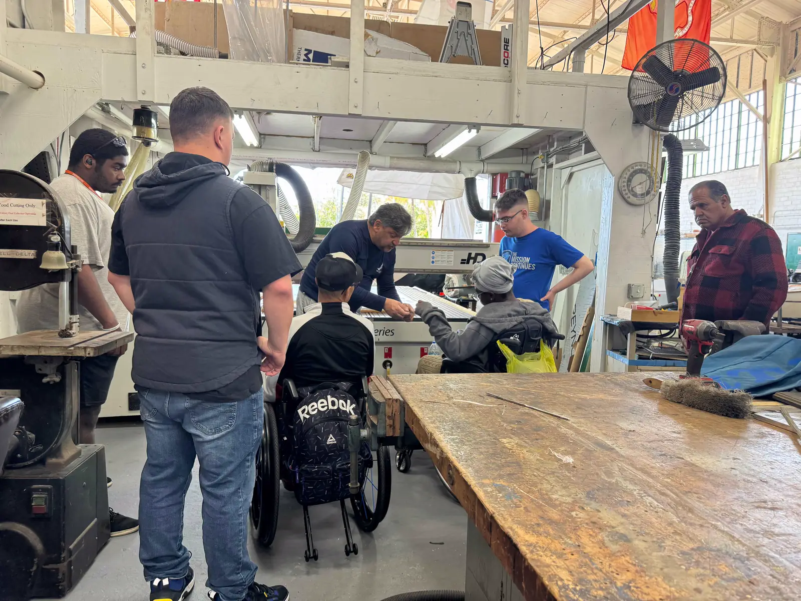 Trainees and instructors at work in the boat shop