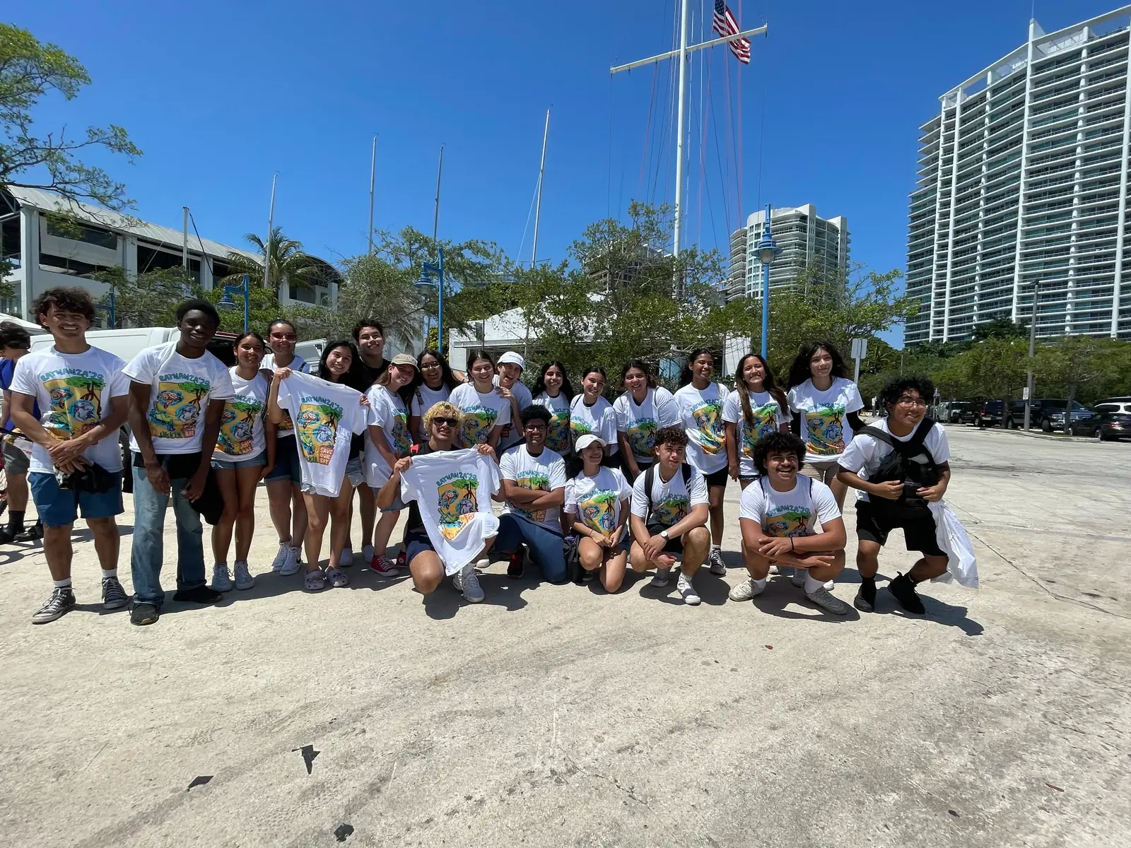 A large group of volunteers posing on the shoreline