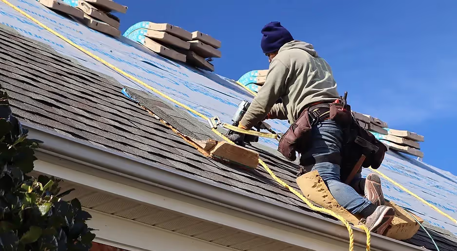 Roofer installing new gutters