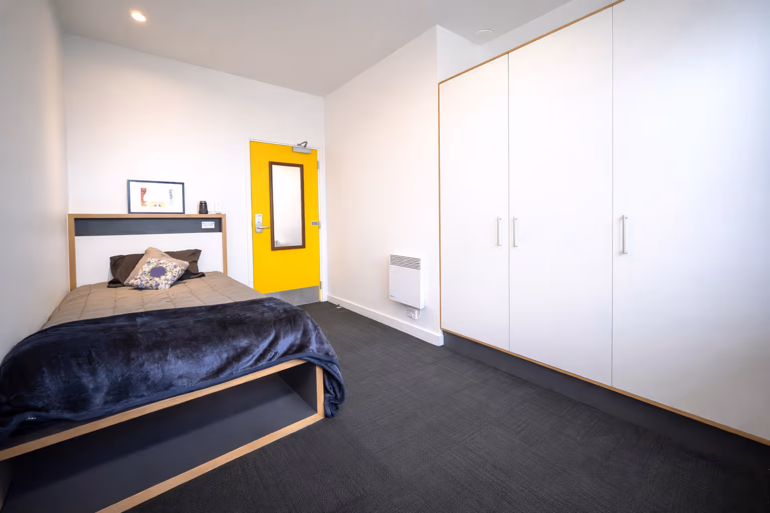 Hatch wintec apartment bedroom featuring bed and wardrobe