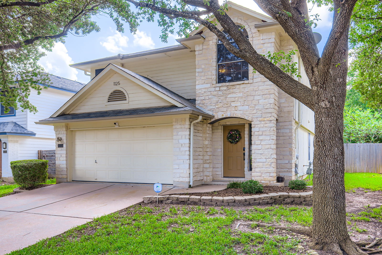 Two-story limestone and siding home in Austin managed by Texas Corporate Homes