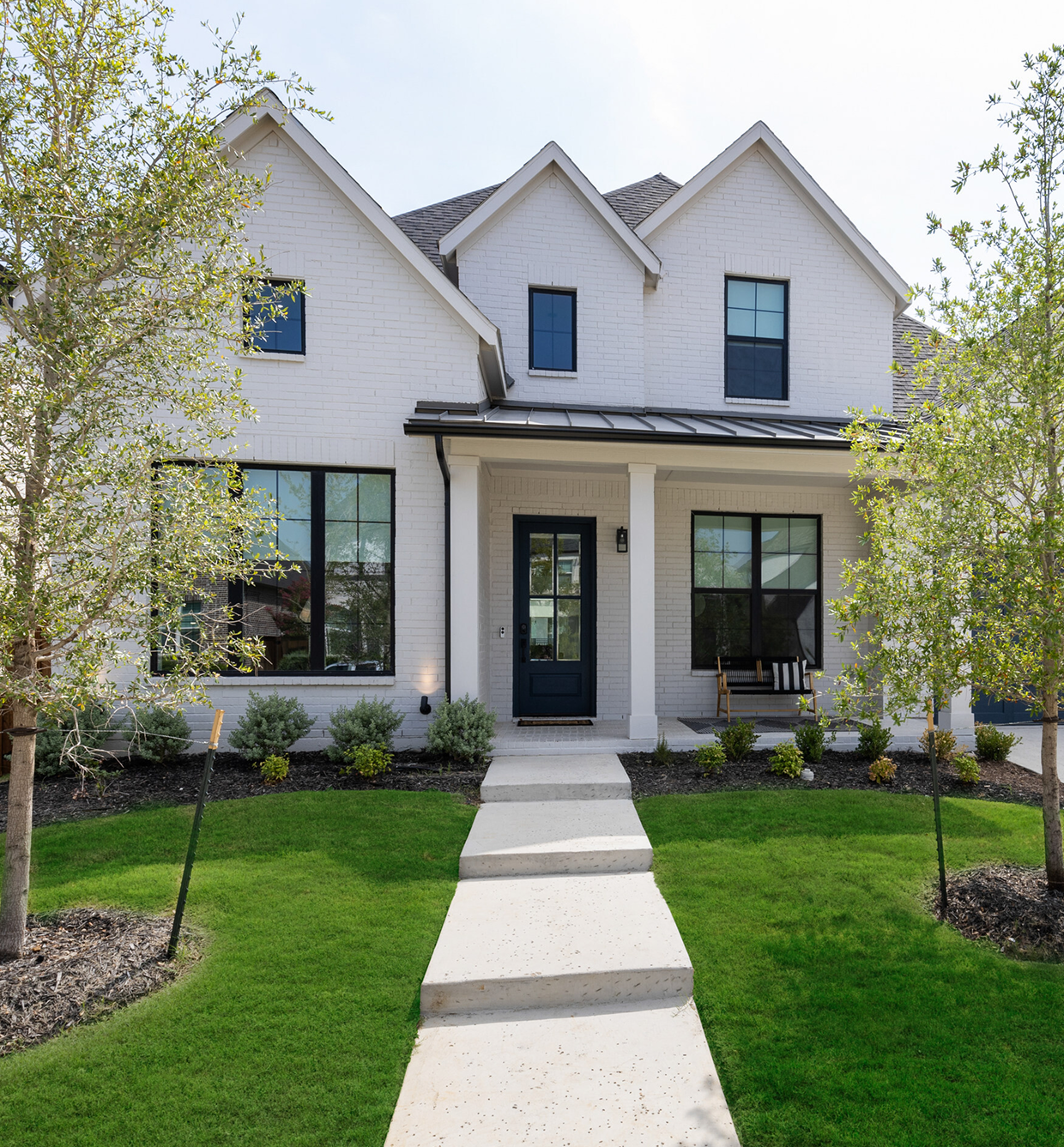 One-story home with a large shade tree and a front lawn.