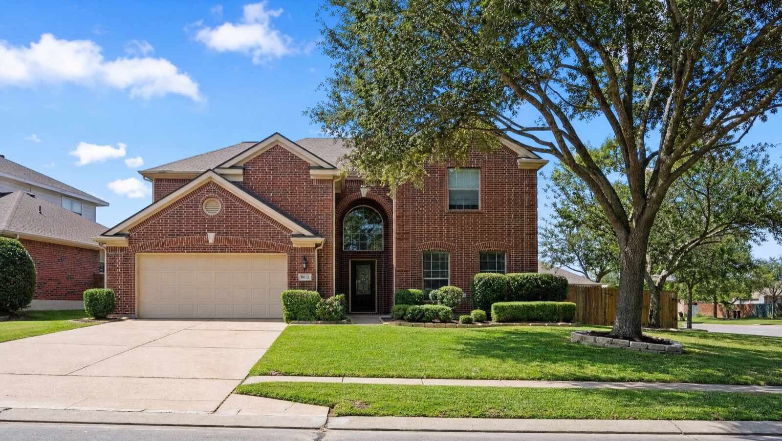 Two-story brick home in a Texas neighborhood