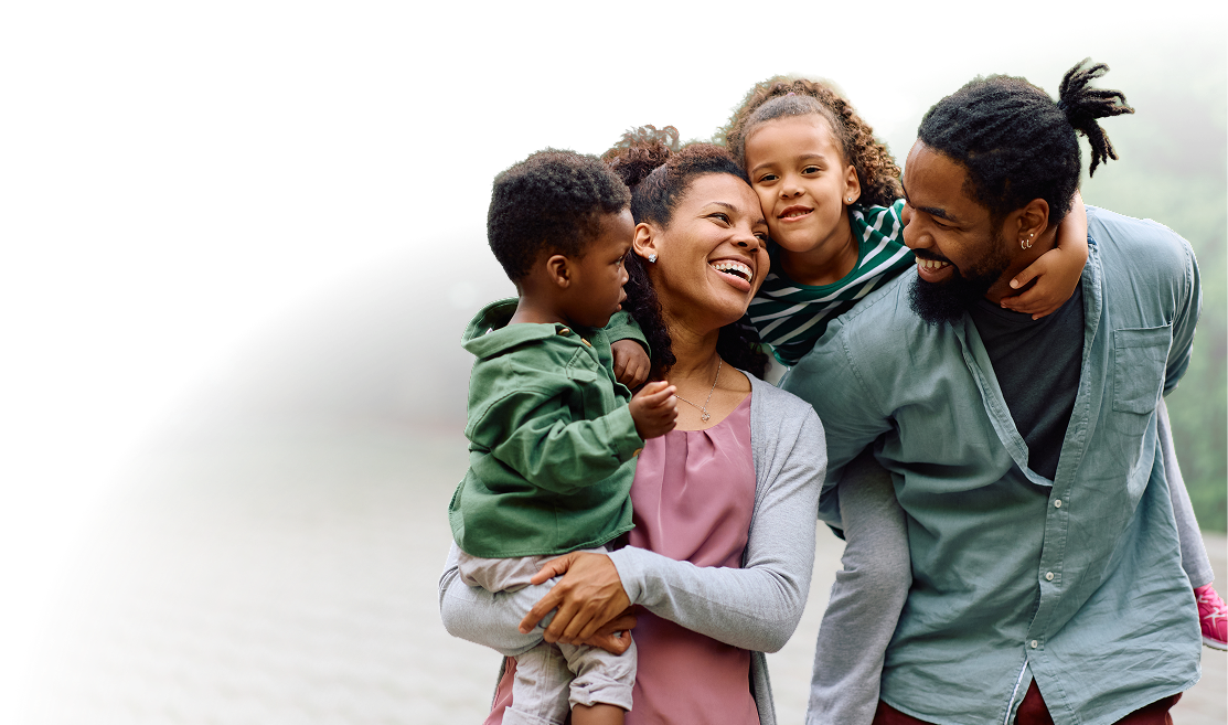 A family of four positively smiling