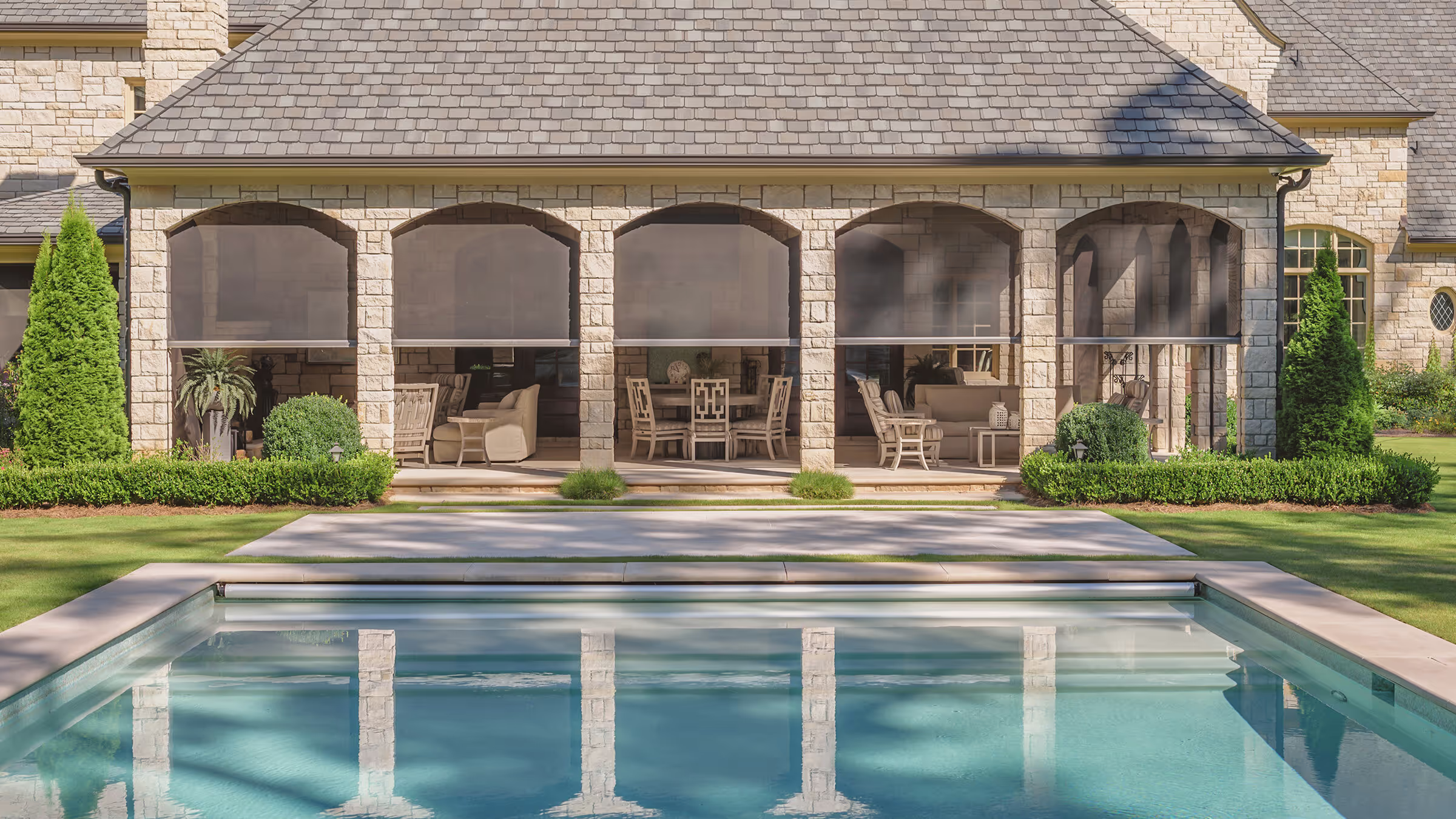 A poolside patio with retractable screens installed.