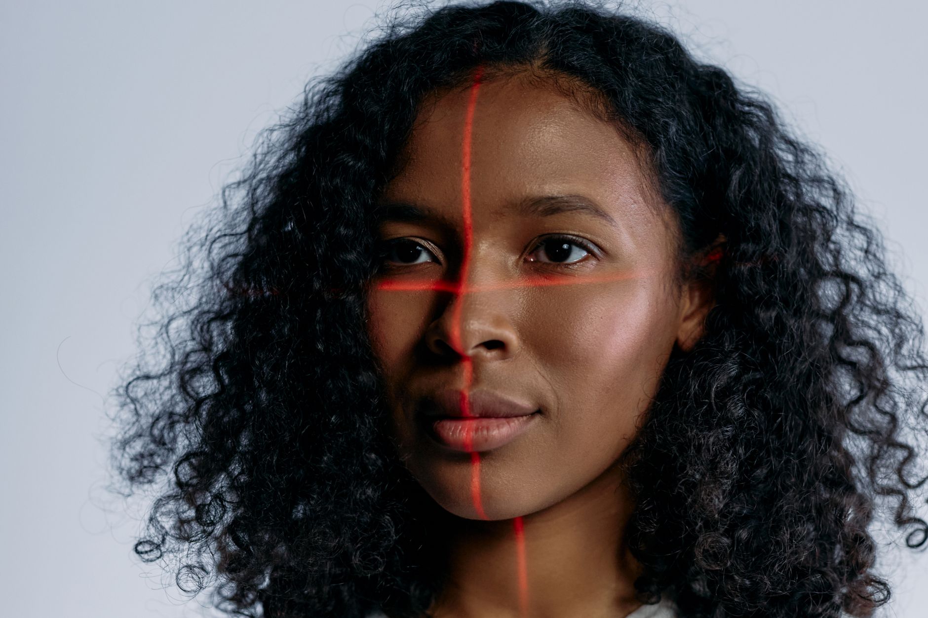 Facial recognition scan with biometric grid overlay representing AI deepfake detection and identity verification