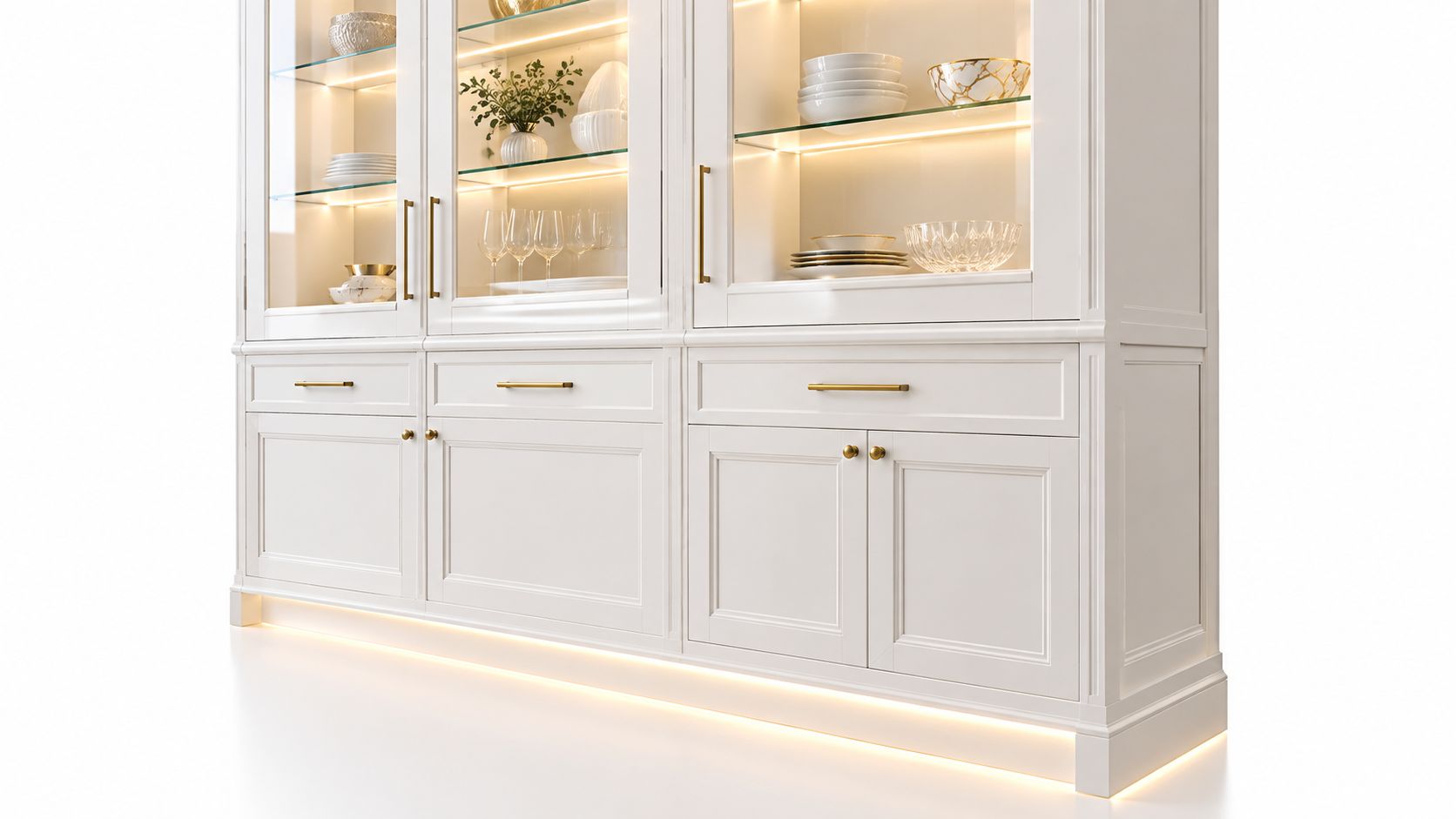 A sophisticated white kitchen display cabinet with integrated warm LED lighting and golden hardware accents.