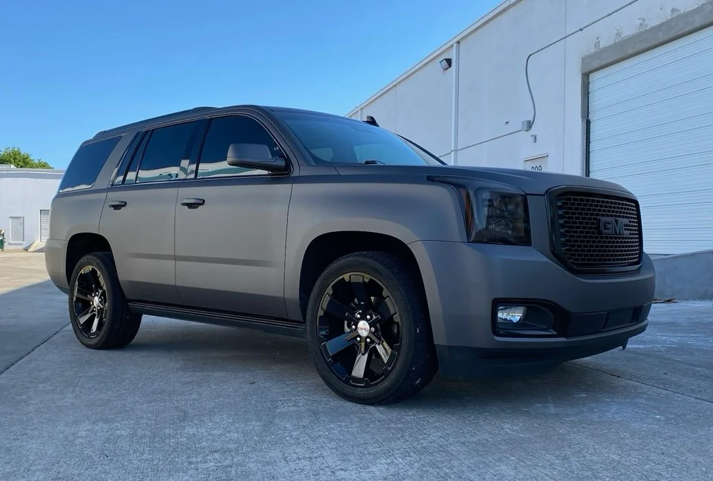 Matte grey GMC Yukon SUV with sleek window tints applied at Allure Auto Spa in Casselberry, Florida