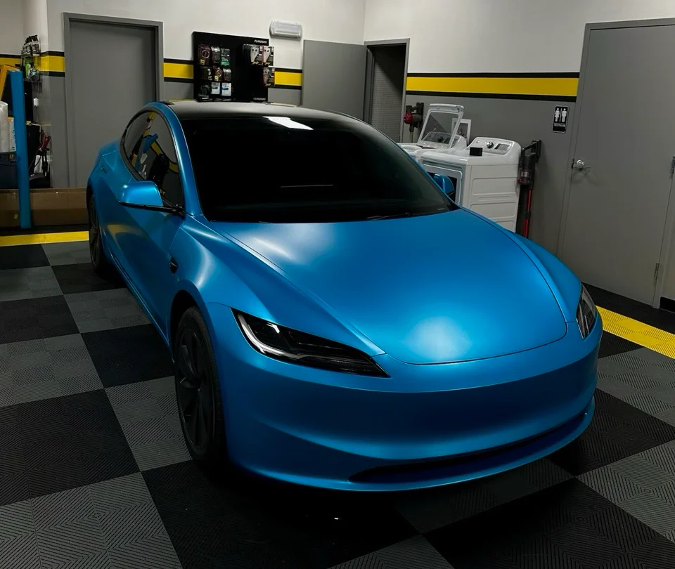 Tesla Model 3 wrapped in satin blue undergoing window tint service at Allure Auto Spa in Casselberry, Florida